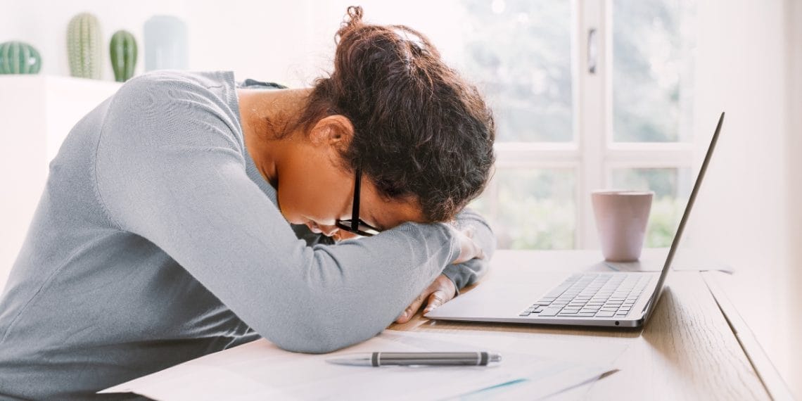 woman laying on her arms with laptop in front of her