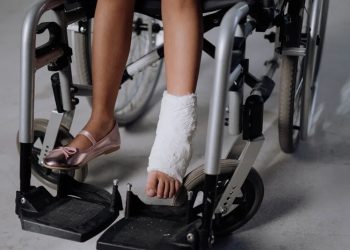 Child in wheelchair with leg cast