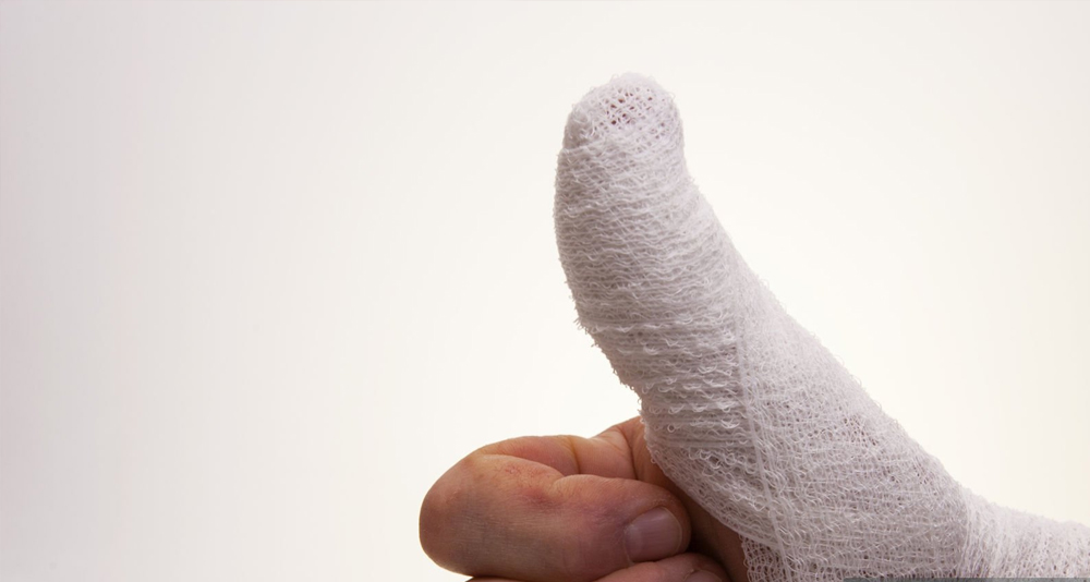 Thumb wrapped in a medical bandage after fracture