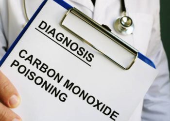 Doctor holding a clipboard with a diagnosis of carbon monoxide poisoning