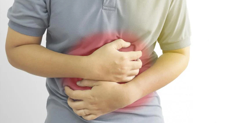Person clutching abdomen to indicate bowel incontinence pain and discomfort