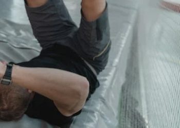 Man holding arm in pain, indicating symptoms of a broken arm