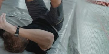 Man holding arm in pain, indicating symptoms of a broken arm