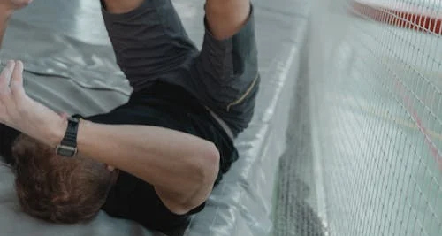 Man holding arm in pain, indicating symptoms of a broken arm