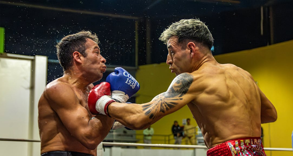 oxer receiving a strong punch to the shoulder during a match