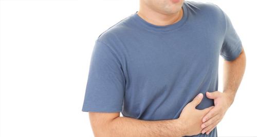 Man holding side of ribcage due to pain caused by trauma or injury