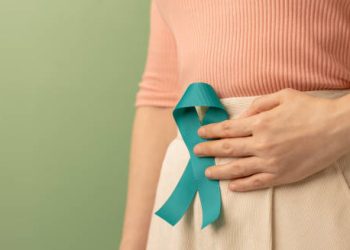 Woman with teal awareness ribbon symbolising cervical cancer awareness
