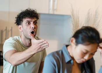 Man shouting at a distressed woman, illustrating emotional conflict and tension related to bipolar disorder complications.