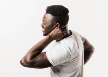 Man holding neck in pain due to cervical discomfort