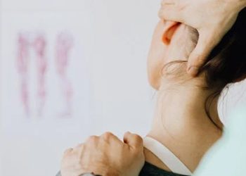 Healthcare provider examining a patient's neck and shoulder for collarbone injur