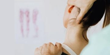 Healthcare provider examining a patient's neck and shoulder for collarbone injur