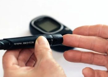 Hand being tested with medical device for carpal tunnel diagnosis