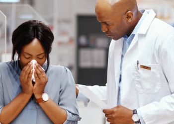 Pharmacist consulting a woman with nasal symptoms
