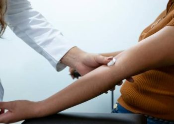 Medical professional examining a patient's arm for signs of cellulitis