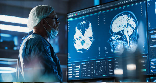 Medical professional analysing brain scans on a screen