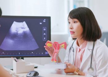 Female doctor explaining cervical anatomy and cancer diagnosis