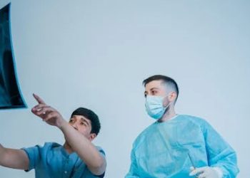 octors examining an X-ray image for nasal injury diagnosis