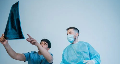 octors examining an X-ray image for nasal injury diagnosis