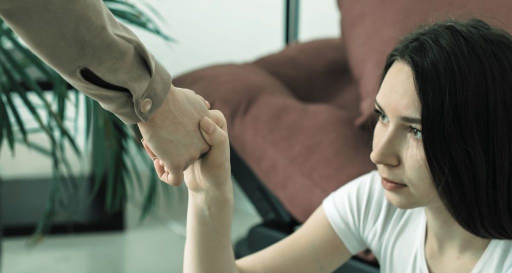 Woman receiving support while experiencing a panic attack