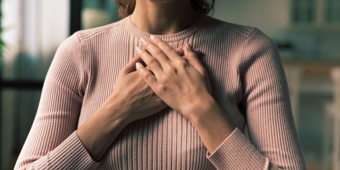 Woman holding her chest during a panic attack