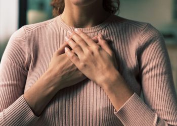 Woman holding her chest during a panic attack
