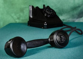 Old-fashioned telephone with receiver off the hook