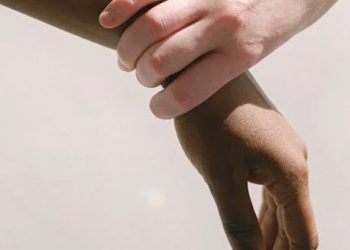 Person holding their wrist in discomfort suggesting carpal tunnel symptoms