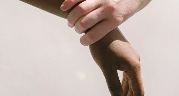 Person holding their wrist in discomfort suggesting carpal tunnel symptoms