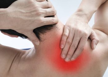 Person holding neck in pain with red inflammation indicating cervical spondylosis