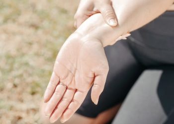 Woman holding wrist in pain due to possible fracture