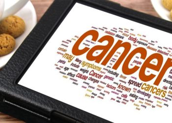 Tablet displaying a word cloud centred around cancer-related terms, including causes, symptoms, and treatments.