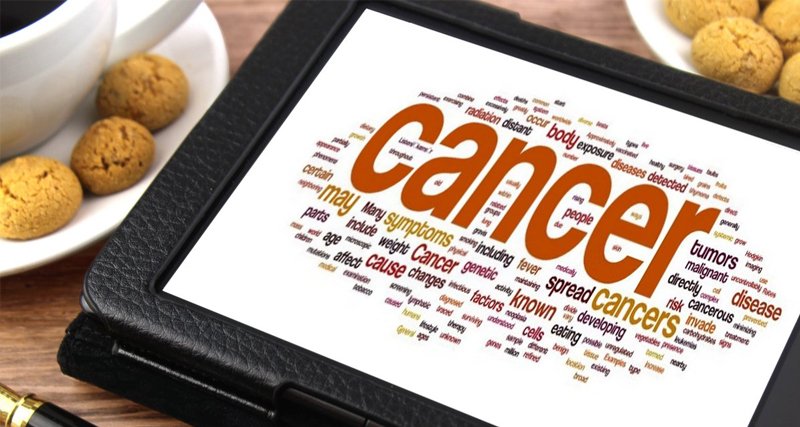 Tablet displaying a word cloud centred around cancer-related terms, including causes, symptoms, and treatments.