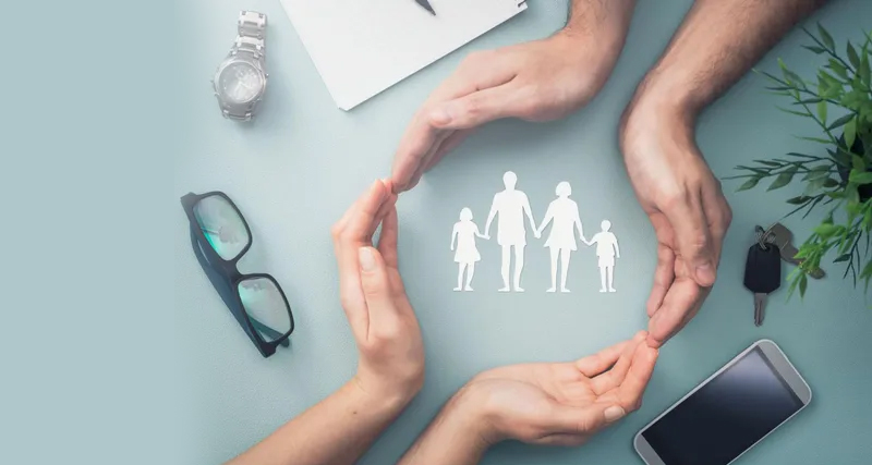 Hands forming a protective circle around a family icon, symbolising care, stability, and treatment support for bipolar disorder.