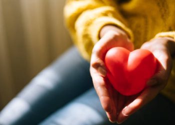 Hands holding a red heart-shaped object symbolising cardiac care