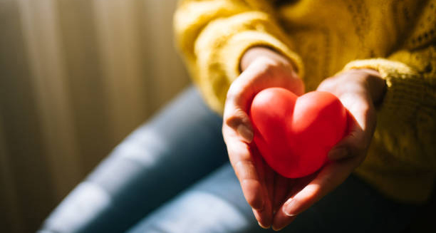 Hands holding a red heart-shaped object symbolising cardiac care