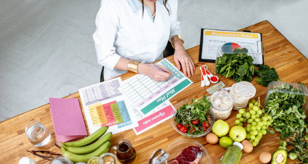 Nutritionist planning a healthy meal plan with fresh fruits and vegetables