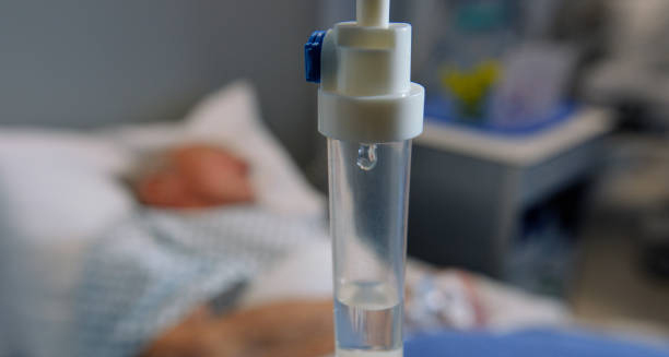 IV drip in focus with patient lying in hospital bed for treatment of cavernous sinus thrombosis