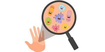 Cartoon germs on hand under magnifying glass illustrating causes of conjunctivitis