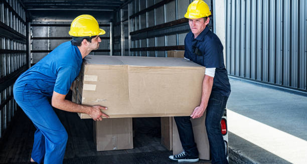 Two workers lifting a heavy box, potentially straining their chest muscles, which can lead to costochondritis.