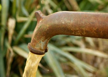 Contaminated water flowing from rusty outdoor tap