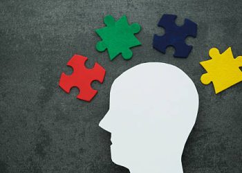 Puzzle pieces around human head representing neurological causes of dyspraxia