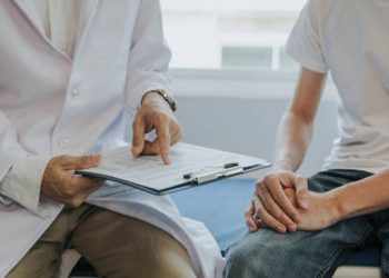 Doctor consulting a male patient about possible causes of erectile dysfunction