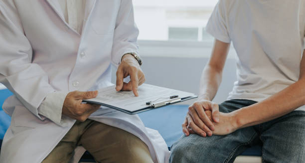 Doctor consulting a male patient about possible causes of erectile dysfunction