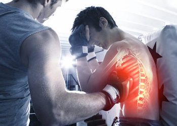Boxer receiving a blow to the ribs with an illustration highlighting rib impact, showing a possible cause of a cracked rib.