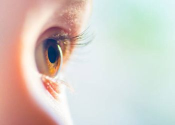 Close-up of a child's eye with visible light reflection
