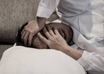 Man in severe pain covering his face due to cluster headache