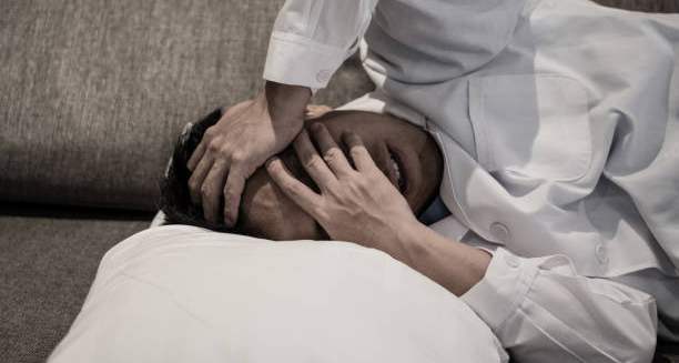 Man in severe pain covering his face due to cluster headache