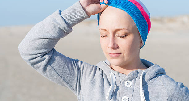 Woman in recovery wearing a colourful beanie after treatment for chronic myeloid leukaemia