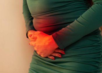 Woman experiencing abdominal pain due to chronic pancreatitis complications.