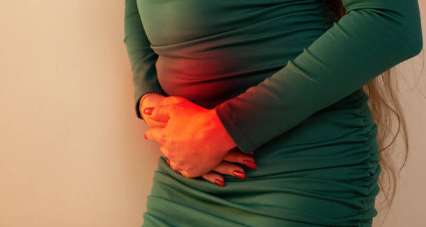 Woman experiencing abdominal pain due to chronic pancreatitis complications.